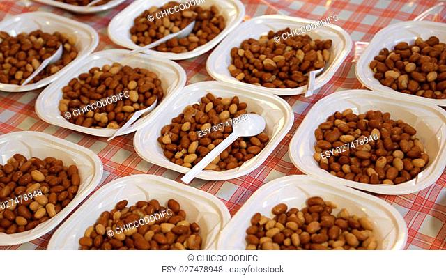 many plastic plates with boiled beans during the village feast