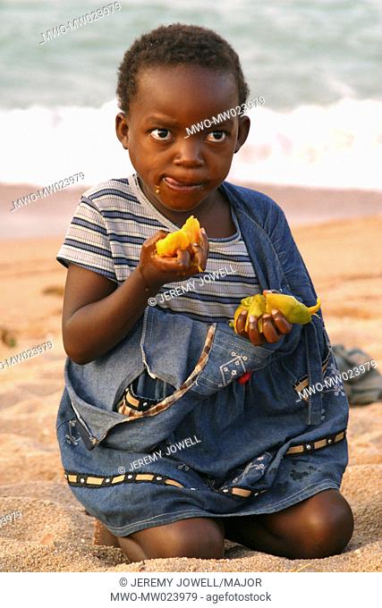 An African girl eats mango on Likoma Island, Malawi October 26, 2005