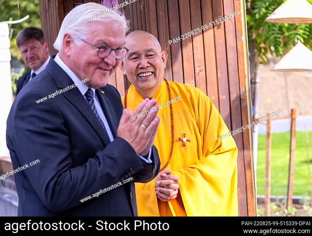 25 August 2022, Mecklenburg-Western Pomerania, Rostock: German President Frank-Walter Steinmeier is greeted by the Reverend Thich Nu Dien during his visit to a...