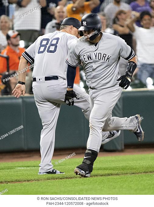 New York Yankees catcher Gary Sanchez (24) celebrates with third base coach Phil Nevin (88) after hitting the game-winning three run home run in the ninth...