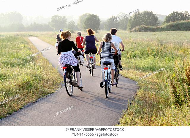 Family trip on bike. People biking through Nature Reserve The Schammer. The Schammer is a area of former farm landscape turned into nature and recreation area
