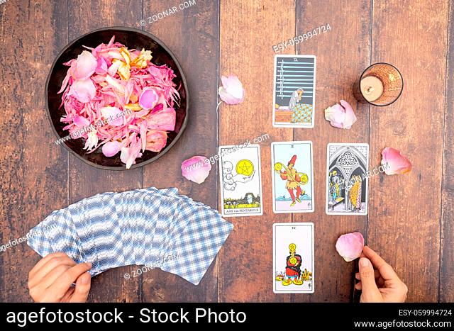 Magical scene, esoteric concept, fortune telling, tarot cards on a table. The concept of divination, astrology and esotericism, illustrative
