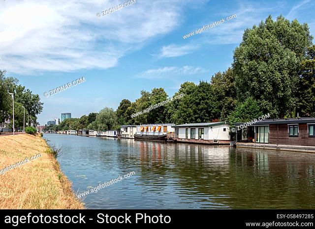 Dutch canal in city Utrecht with several moored houseboats
