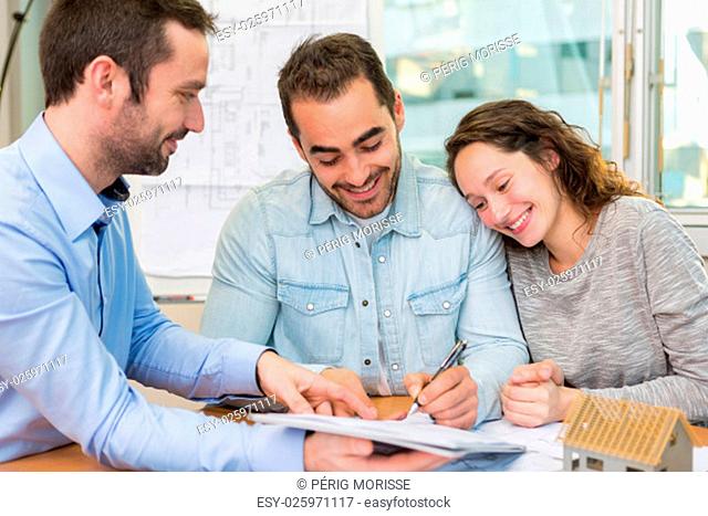 View of a Young attractive people signing cotract with meeting real estate agent