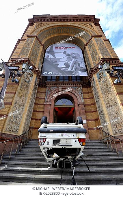 Art and culture, old car wreak on its roof in the front entrance of the Altes Postfuhramt, Old Royal Post Office, Berlin, Germany, Europe, PublicGround