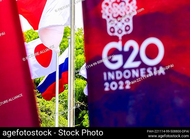 14 November 2022, Indonesia, Nusa Dua: The flag of Russia flies next to that of Japan in front of the media center of the G20 summit
