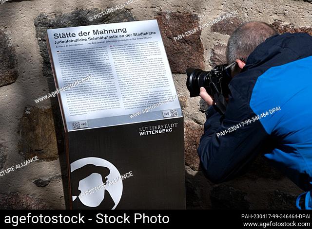 17 April 2023, Saxony-Anhalt, Lutherstadt Wittenberg: A new text can be seen on an information board below the invective sculpture known as the ""Judensau"" at...