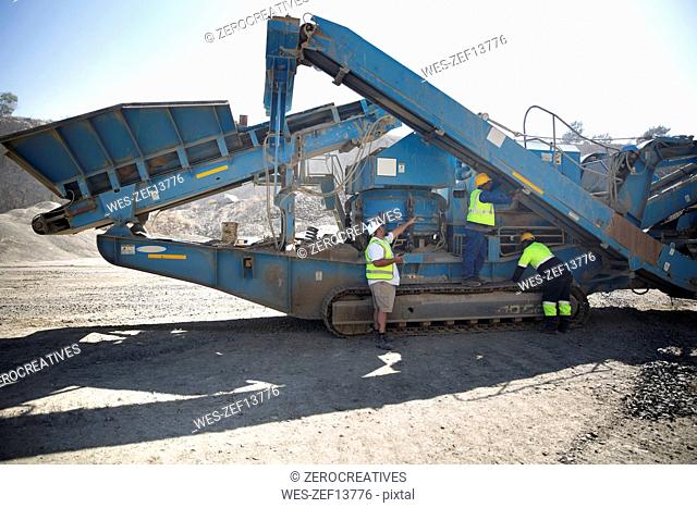 Workers in quarry maintaining dragline