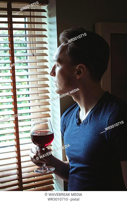 Thoughtful man having red wine