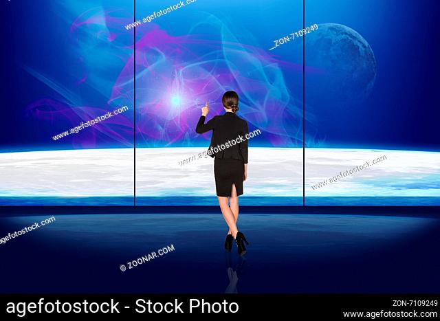 Woman looking at the outspace through a window