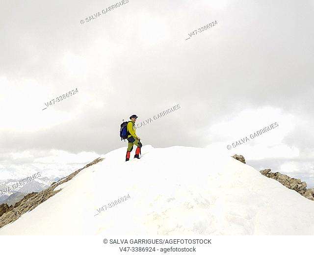 Mountaineer ascending to the peak of Vallibierna, Huesca, Aragon, Spain