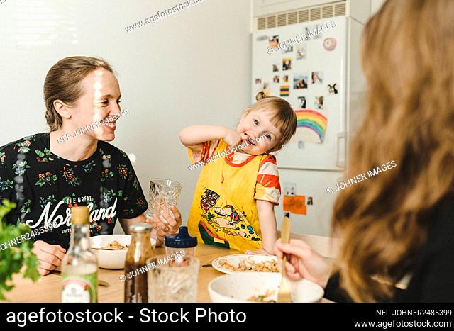 Mother with daughter sitting at table