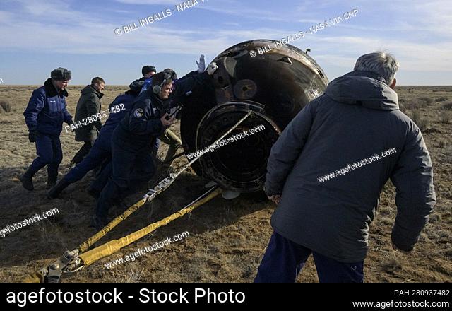 Russian Search and Rescue teams arrive at the Soyuz MS-19 spacecraft shortly after it landed in a remote area near the town of Zhezkazgan