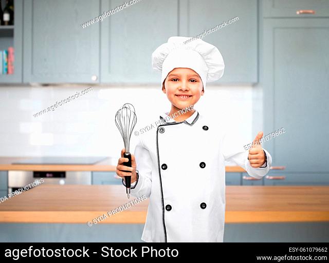 girl in chef's toque with whisk showing thumbs up