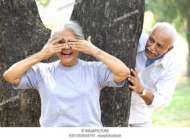 Old couple playing hide and seek