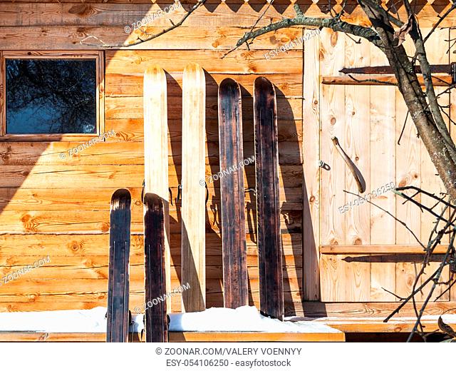 wide hunting skis in front of wooden cottage in sunny winter day in russian village in Smolensk region of Russia