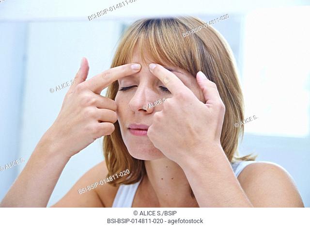 Woman massaging her face