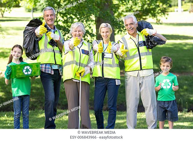 Happy family collecting rubbish with thumbs up