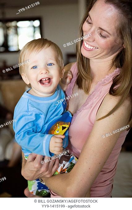 Young mother holding smiling baby boy - Fort Lauderdale, Florida USA