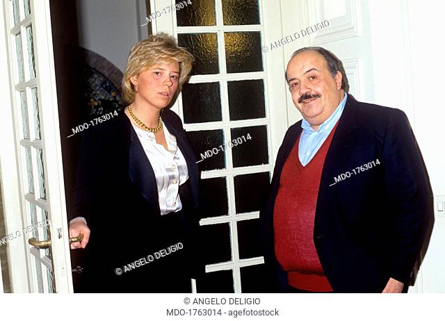 Maria De Filippi opening a door beside Maurizio Costanzo . Italian journalist and TV host Maurizio Costanzo smiling beside his future wife and Italian Tv...