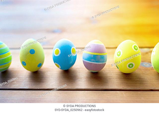 colored easter eggs on wooden surface