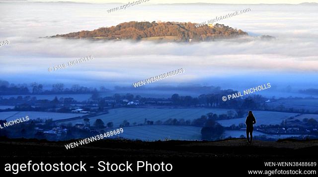 St Bartholomew's Church in Churchdown, Gloucestershire, is bathed in early morning sunlight and surrounded by fog on the morning of Thursday 13th January 2022