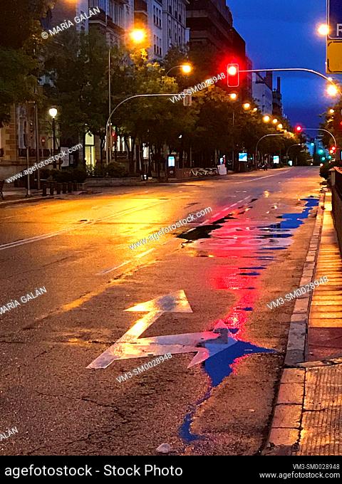 Wet pavement, night view. Jose Ortega y Gasset street, Madrid, Spain