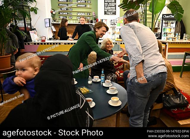 30 March 2023, Berlin: Royal wife Camilla (center) accompanied by Elke Büdenbender (2nd from left) visits the Refugio Berlin on the second day of her trip to...