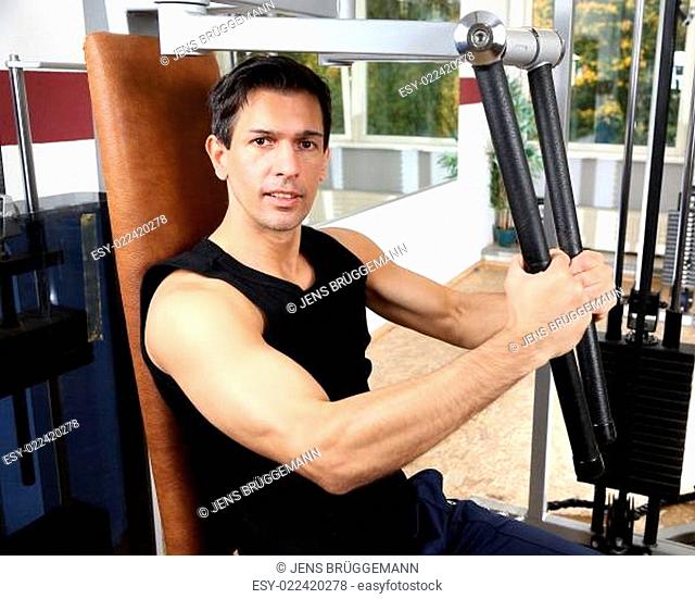 Handsome man working out in a gym