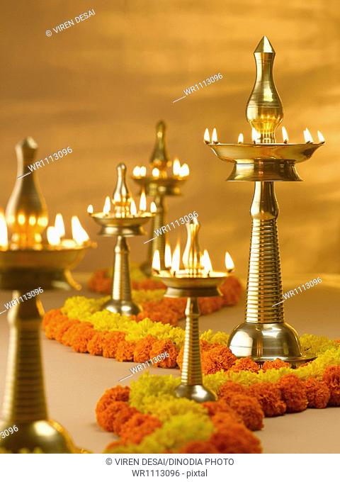 Brass lamps and flowers decoration during diwali festival ; India