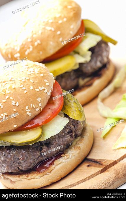 homemade hamburger with pickled cucumber and tomato