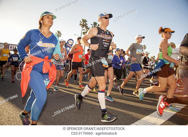 Half marathon runners find their pace on Pacific Coast Highway in Newport Beach, CA