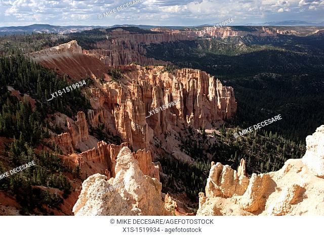 Partly cloudy sky over Bryce Canyon in Utah produces undulating dark and light patches on the famous sandstone spires