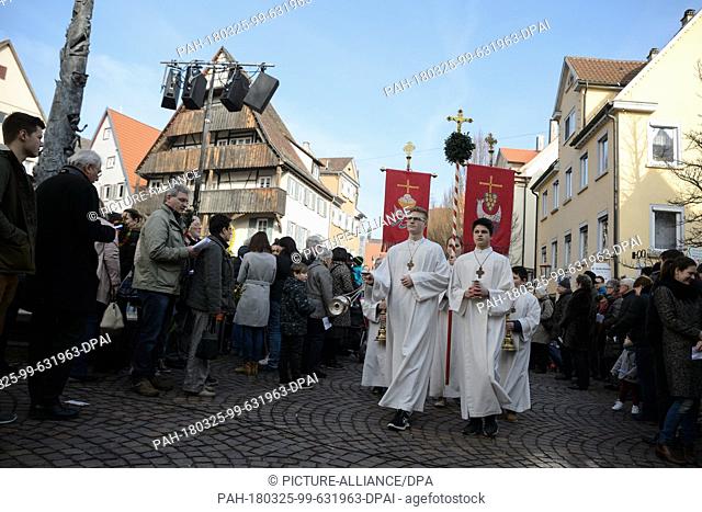 25 March 2018, Germany, Rottenburg/Neckar: A procession moves through the town centre on Palm Sunday. Christian commemorate the day on which Jesus entered...