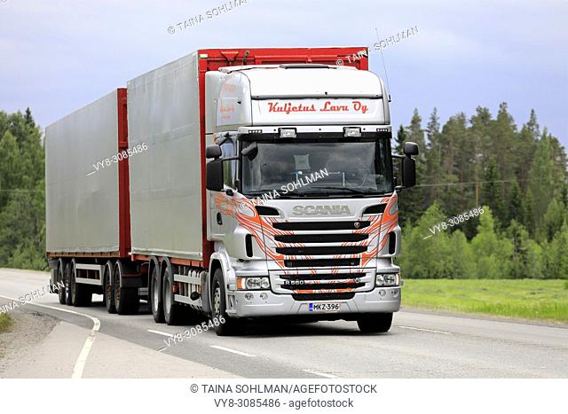 Scania R560 truck and full trailer cargo transporter of Kuljetus Lavu Oy on highway in summer. Uurainen, Finland - June 15, 2018
