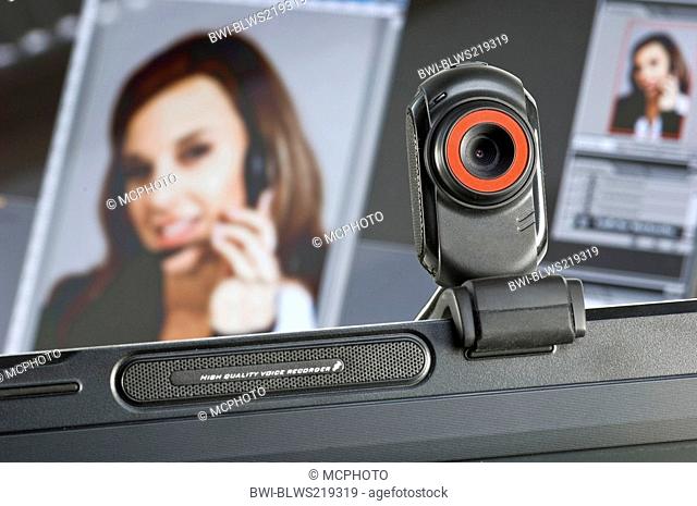 webcam installed on computer monitor, portrait of a woman in the background