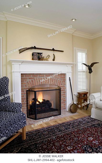 FIREPLACES: contemporary country, brick fireplace surround, traditional molding, shutters, wing chair with coverlet fabric, eagle on stand