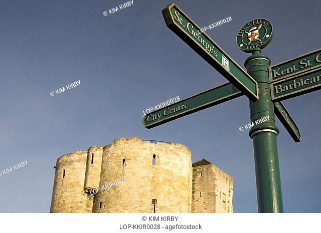 England, North Yorkshire, York, A tourist information signpost with Cliffords Tower in the background