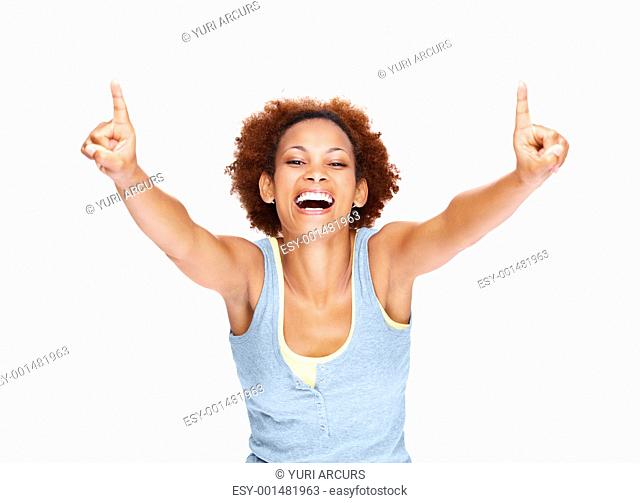Portrait of overjoyed young lady pointing up with both hands against white background