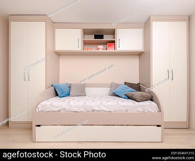 Modern beige bedroom with wardrobe and double bed