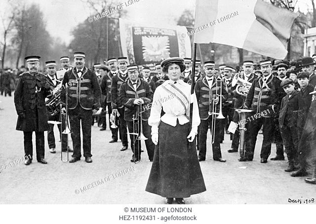 Daisy Dugdale leading the procession to welcome Emmeline and Christabel Pankhurst, London, 19th December 1908. Wearing the suffragette uniform in the colours of...
