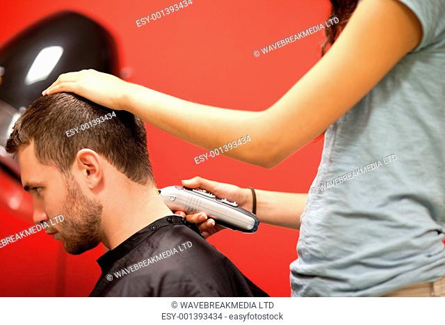 Male student having a haircut with a hair clippers