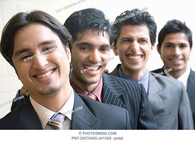 Portrait of four business executives smiling