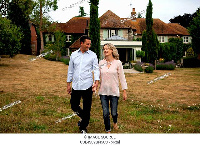 Romantic mature couple strolling in garden