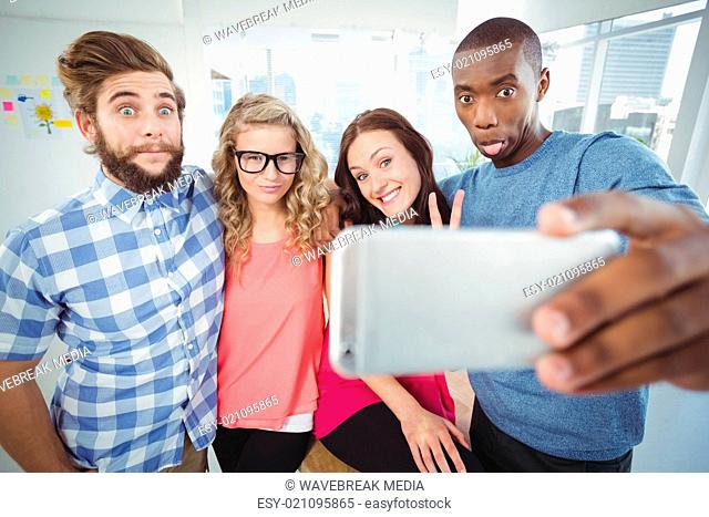 Business people making face while taking selfie