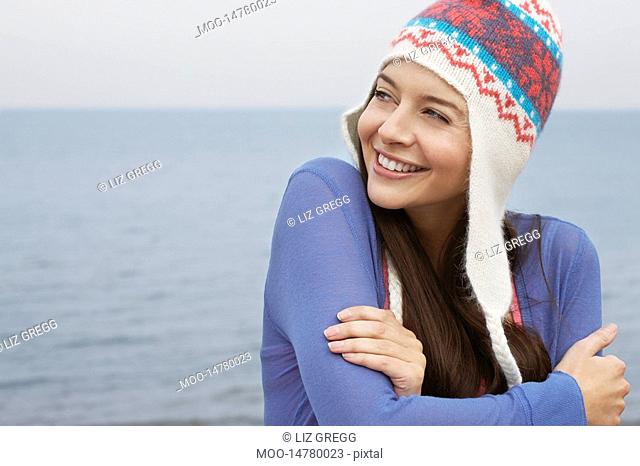 Young woman wearing wool hat on beach portrait