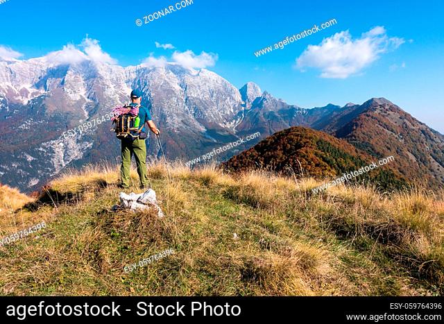 Man hiker watch the landscape of mountain in autumn from the mountain top