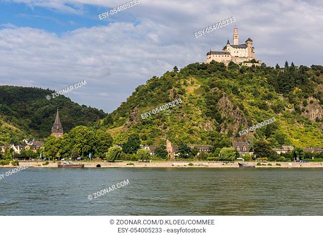 Marksburg Castle on a hill with the Rhine and ship in Braubach, Germany
