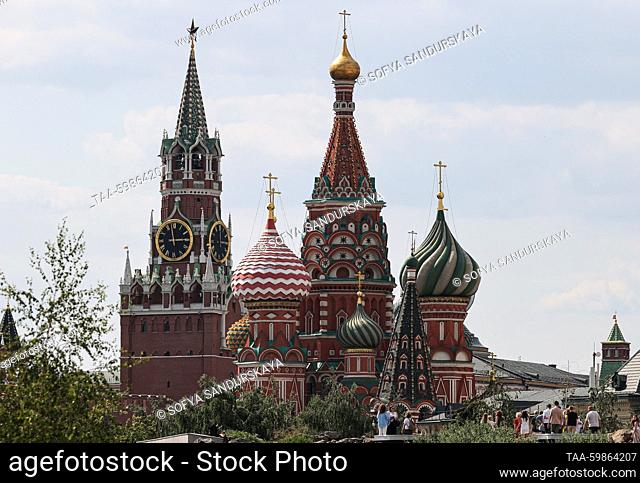 RUSSIA, MOSCOW - JUNE 16, 2023: A view of the Moscow Kremlin's Spasskaya Tower and St Basil's Cathedral from Zaryadye Park