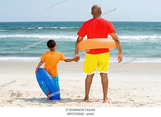 Father and son with inflatable rings